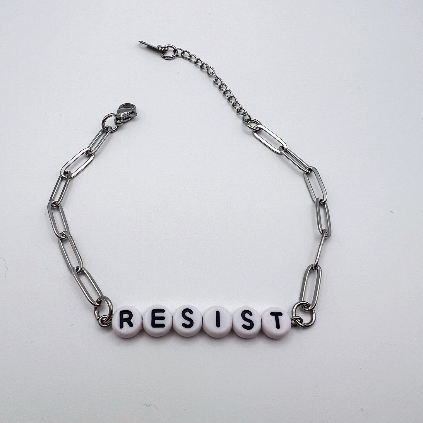 Bracelet with 'RESIST' beads on a white background