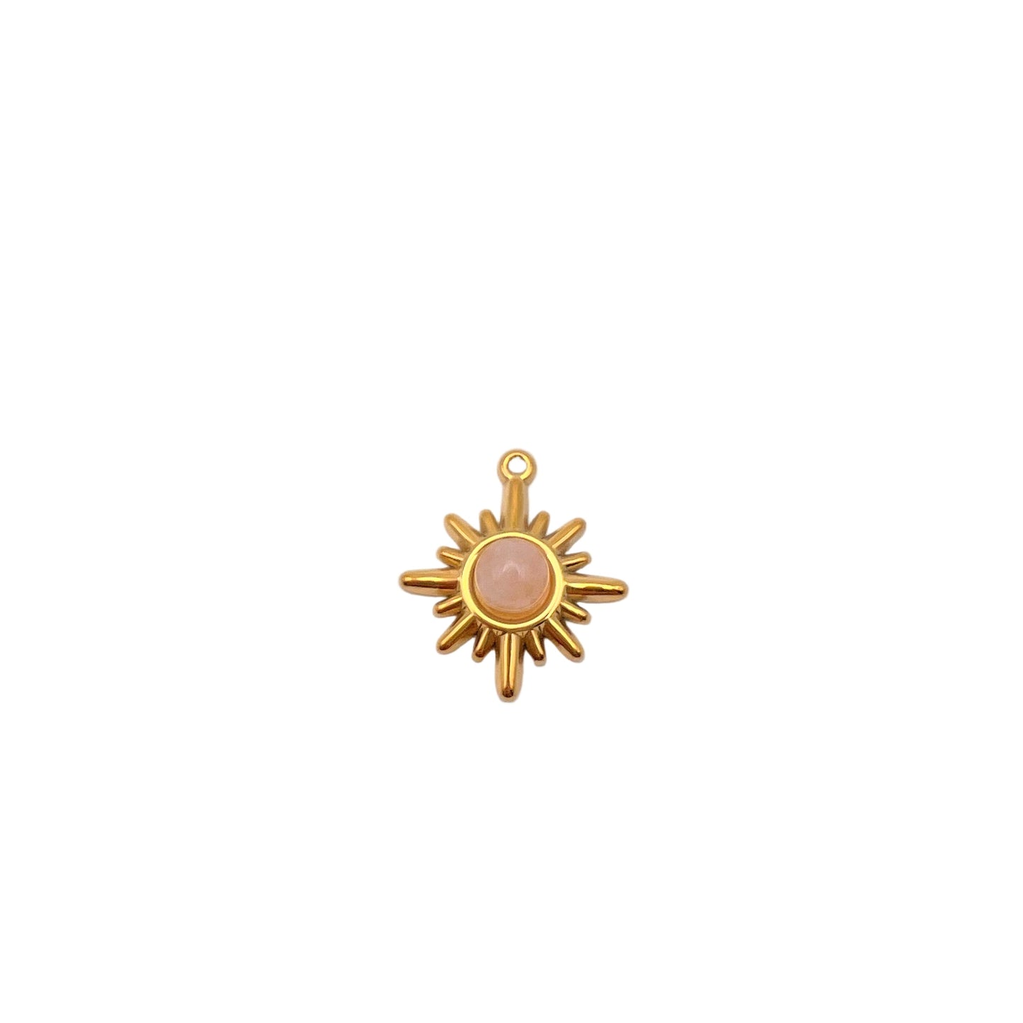 Gold sun-shaped pendant with a pink stone on a light gray background