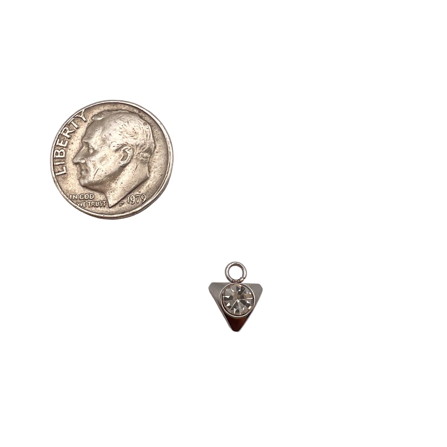 Small silver teardrop pendant next to a quarter on a light gray background