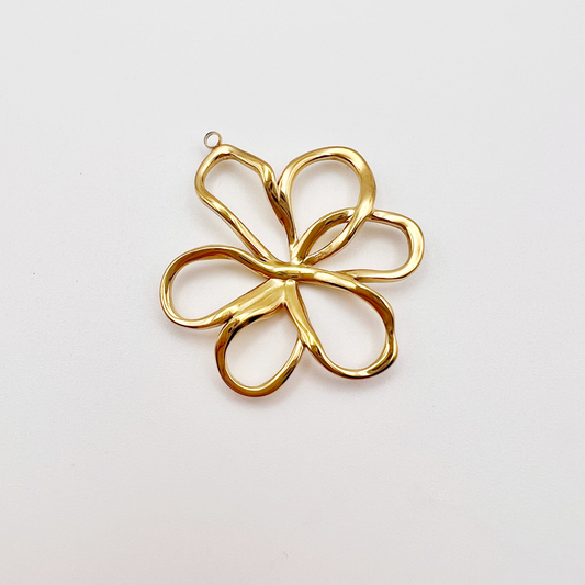 Gold flower-shaped pendant on a light gray background
