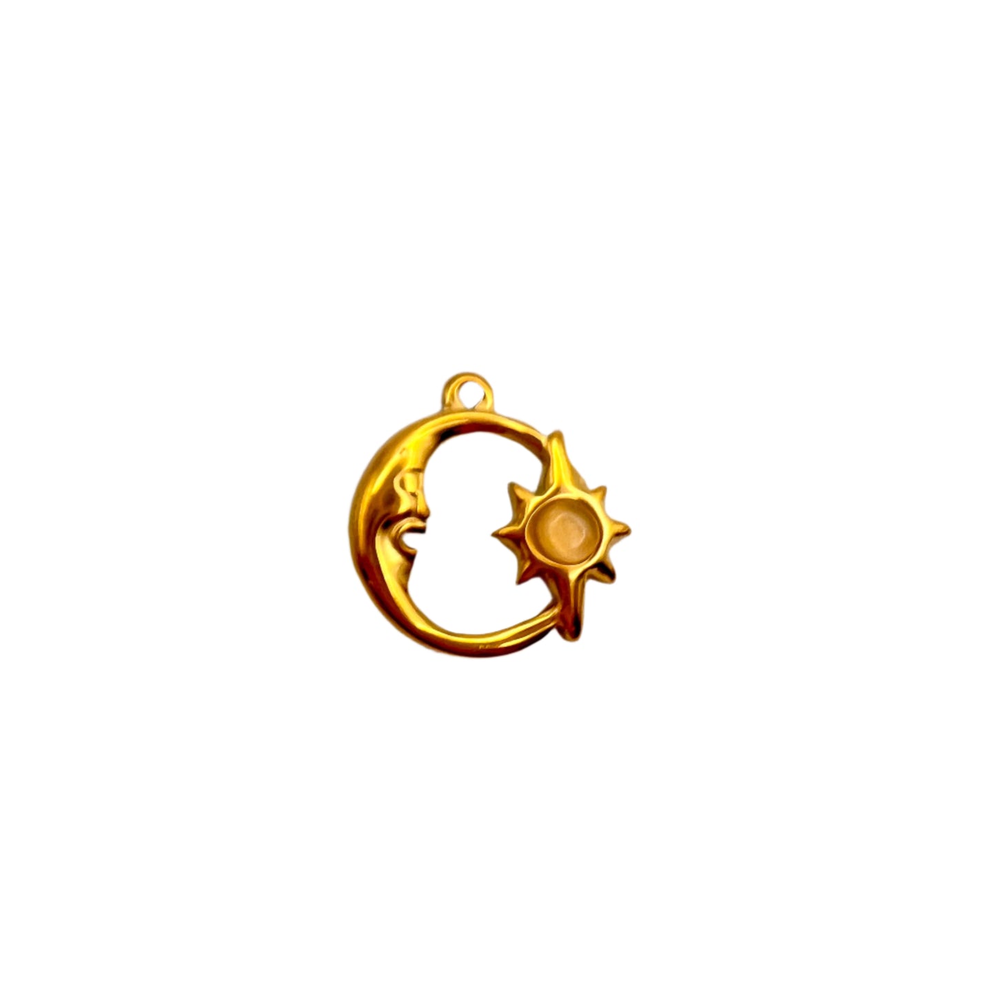 Gold pendant with moon and sun design on a light gray background