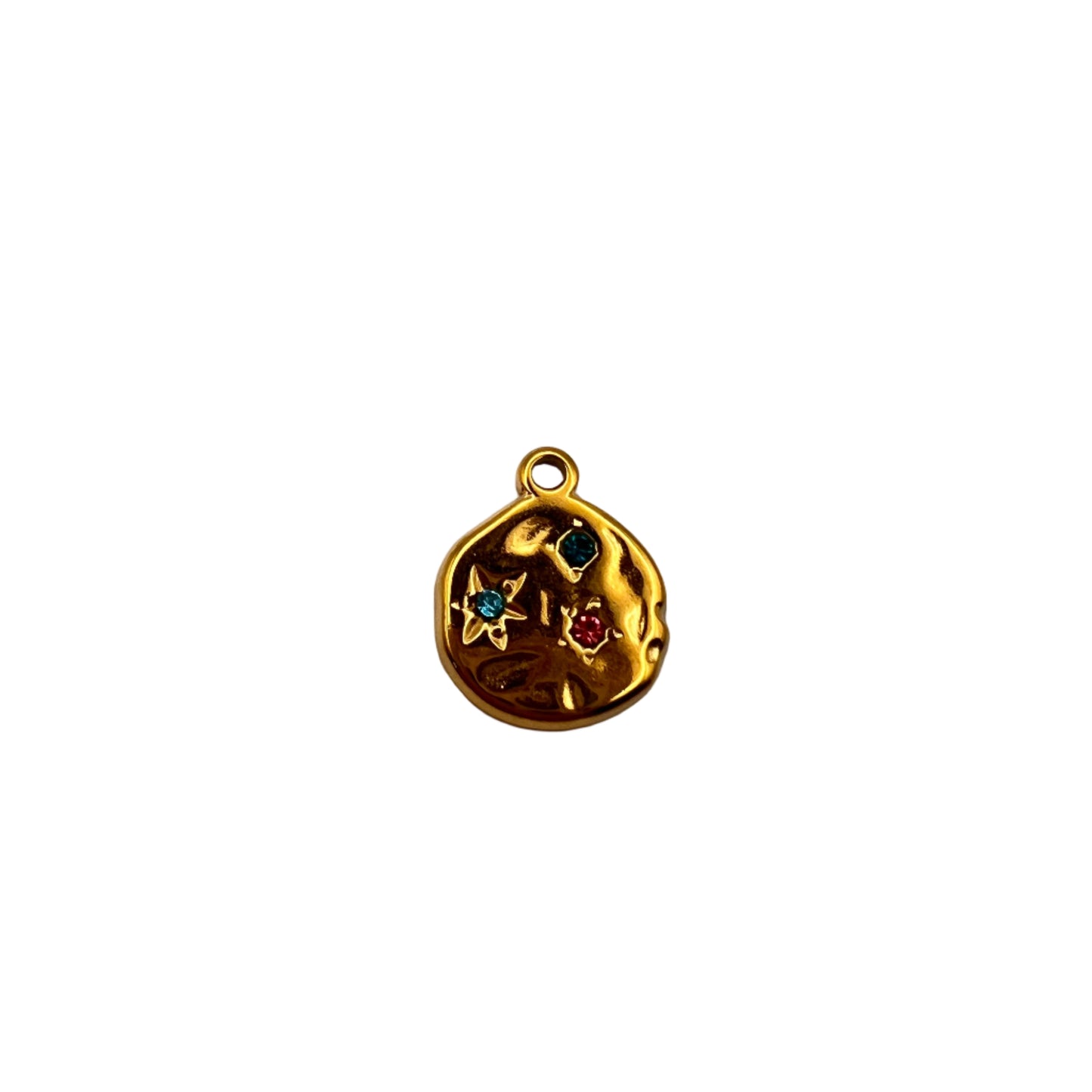 Gold charm with embedded stones on a light gray background