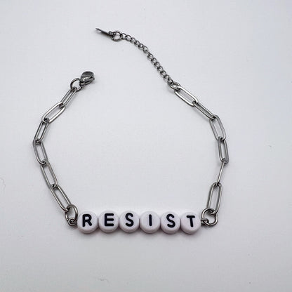 Bracelet with 'RESIST' beads on a white background