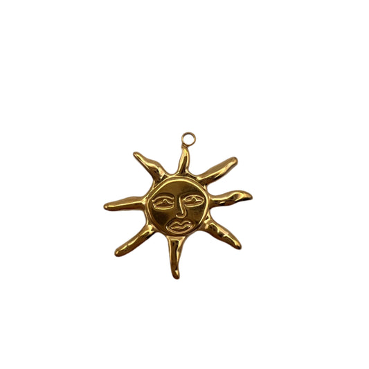 Gold sun-shaped pendant on a white background