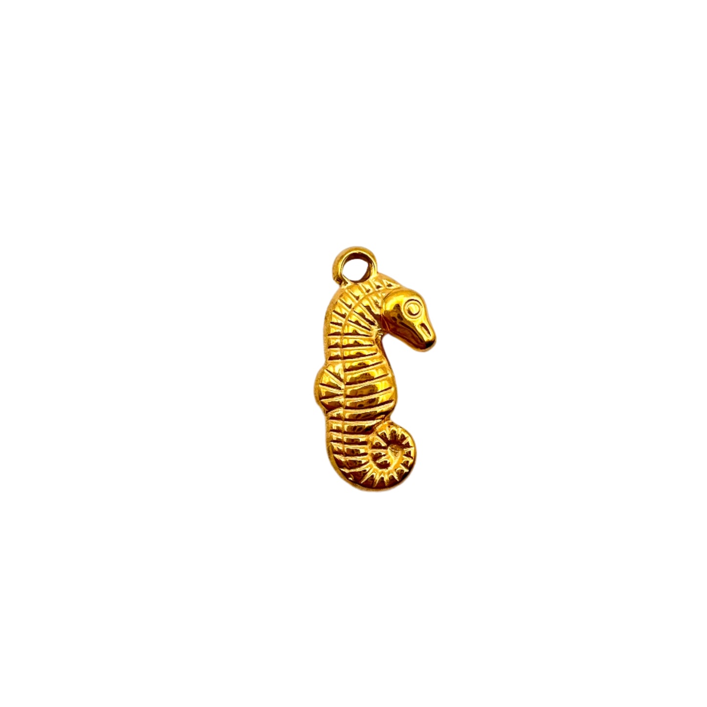 Gold seahorse charm on a white background