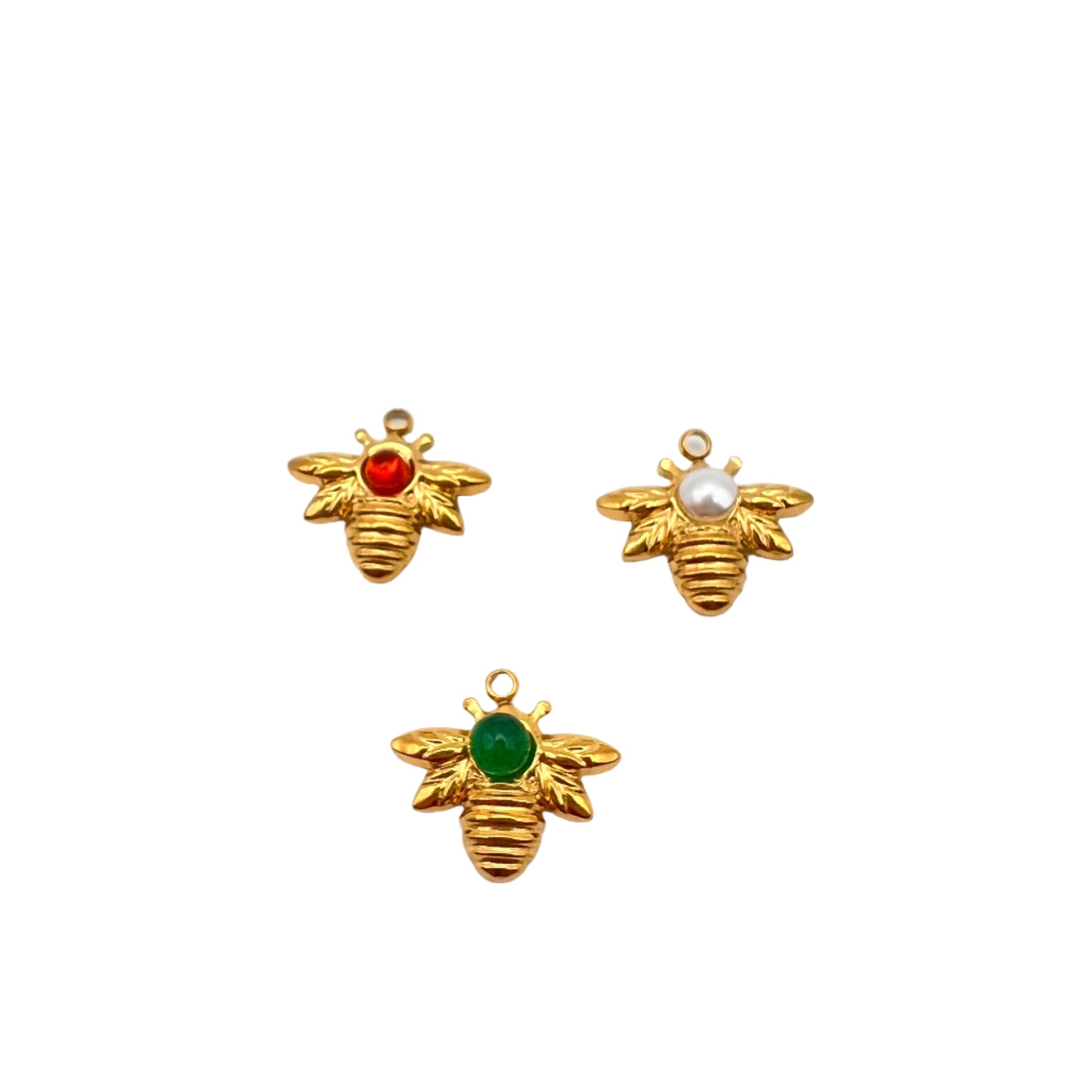 Three gold bee-shaped charms with colored centers on a white background