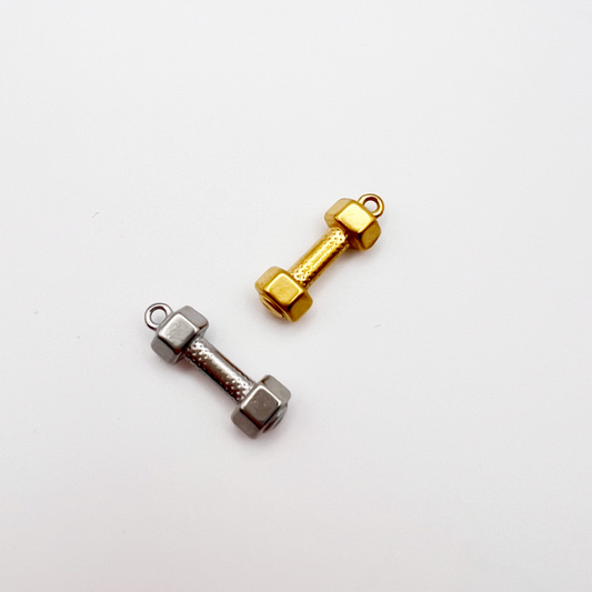 Two dumbbell-shaped charms, one gold and one silver, on a white background.