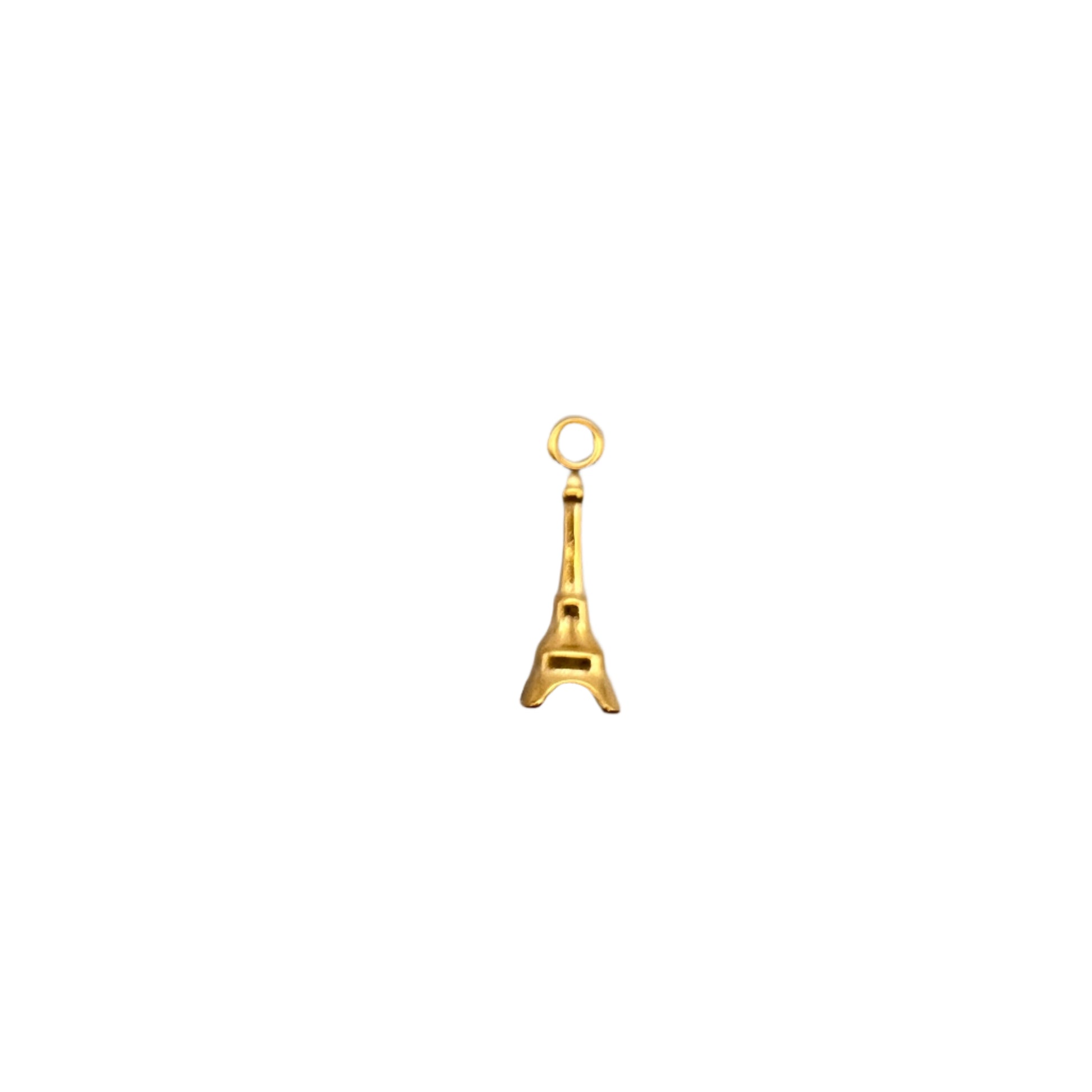 Gold eiffel tower charm on a light gray background