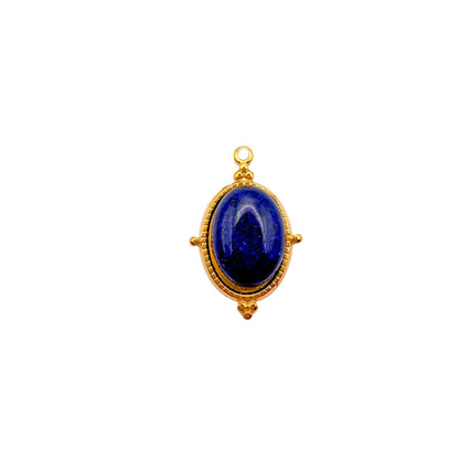 Gold pendant with a blue gemstone on a white background