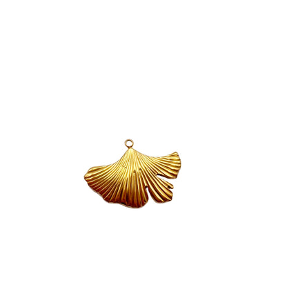 Gold shell-shaped pendant on a light gray background