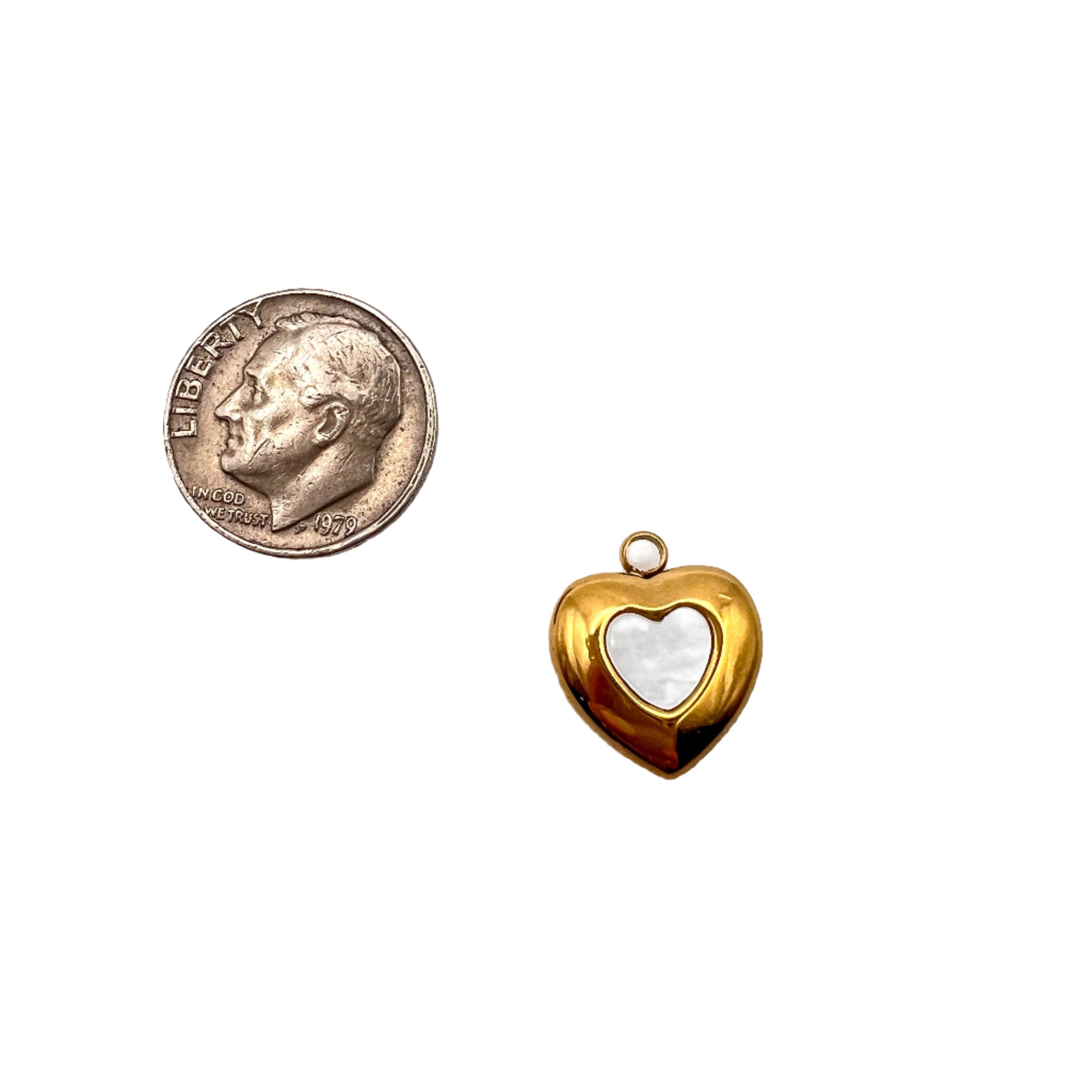 Gold heart-shaped pendant next to a U.S. quarter on a white background