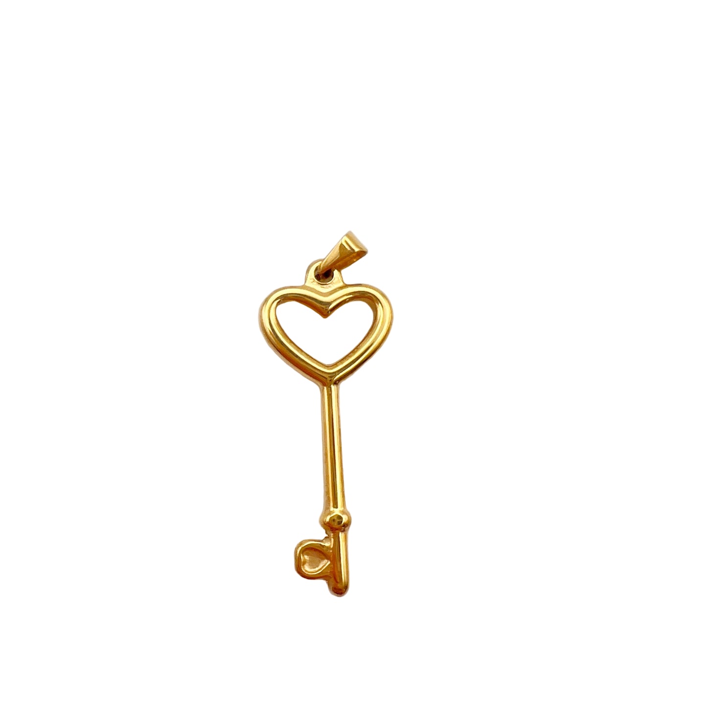 Gold key-shaped pendant with heart design on a light gray background