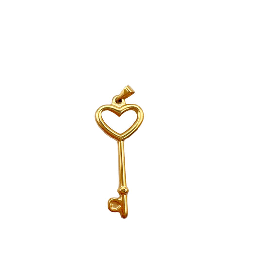 Gold key-shaped pendant with heart design on a light gray background