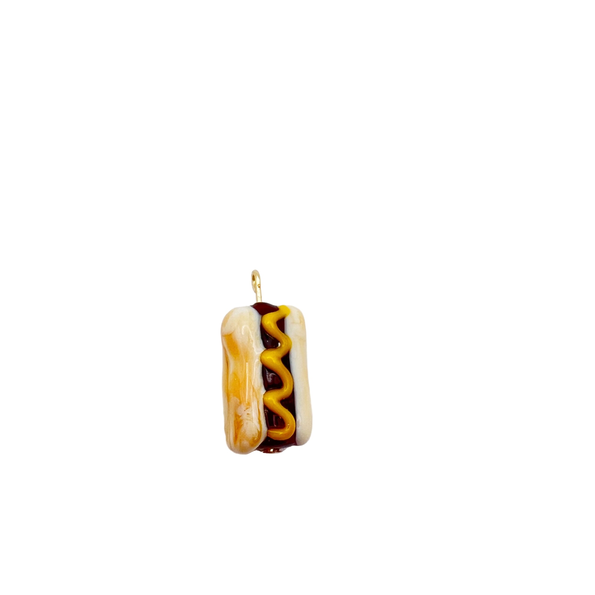 Hot dog-shaped pendant with mustard and ketchup on a white background