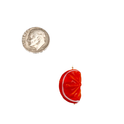 Red and white striped candy with a quarter for scale on a white background