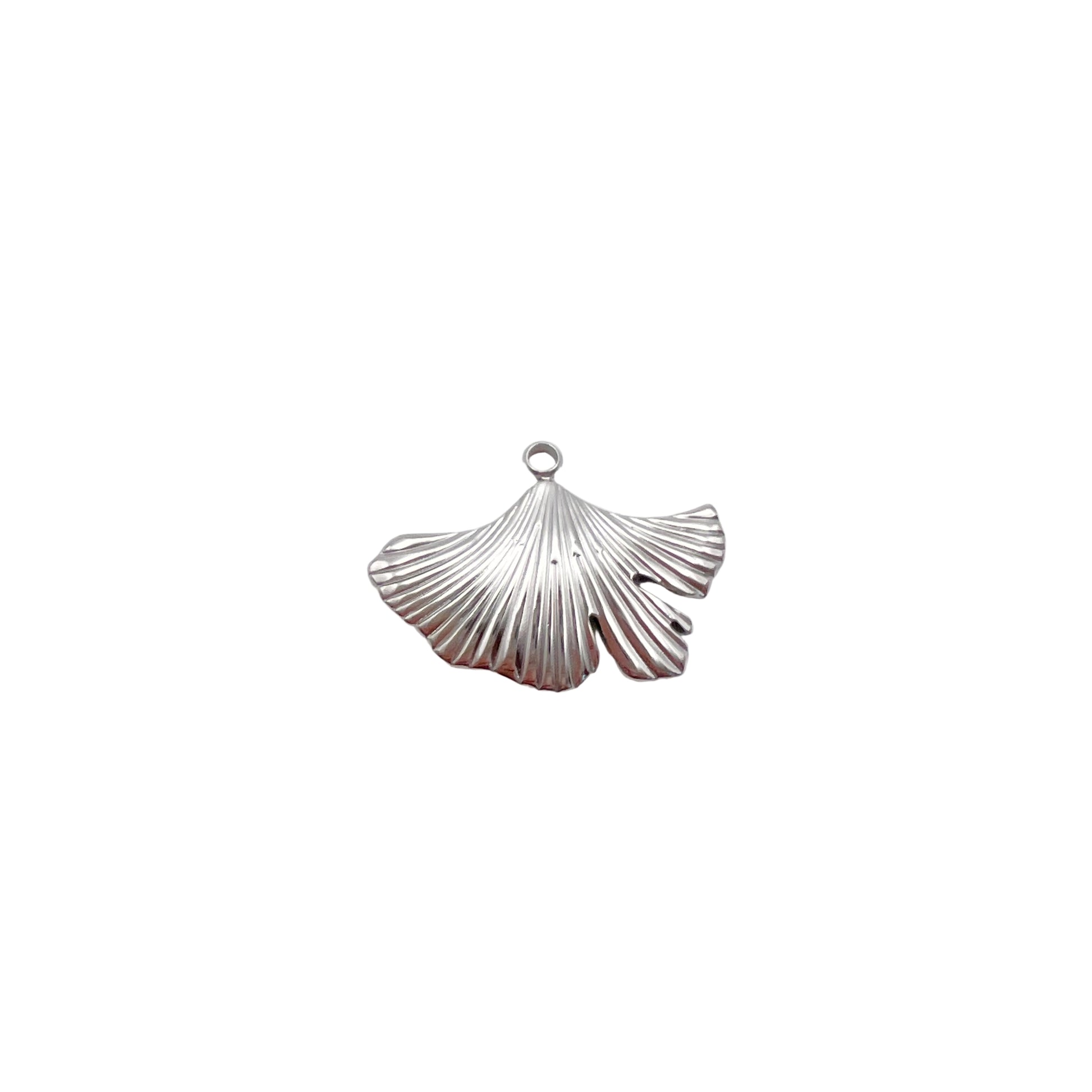 Silver shell pendant on a light gray background