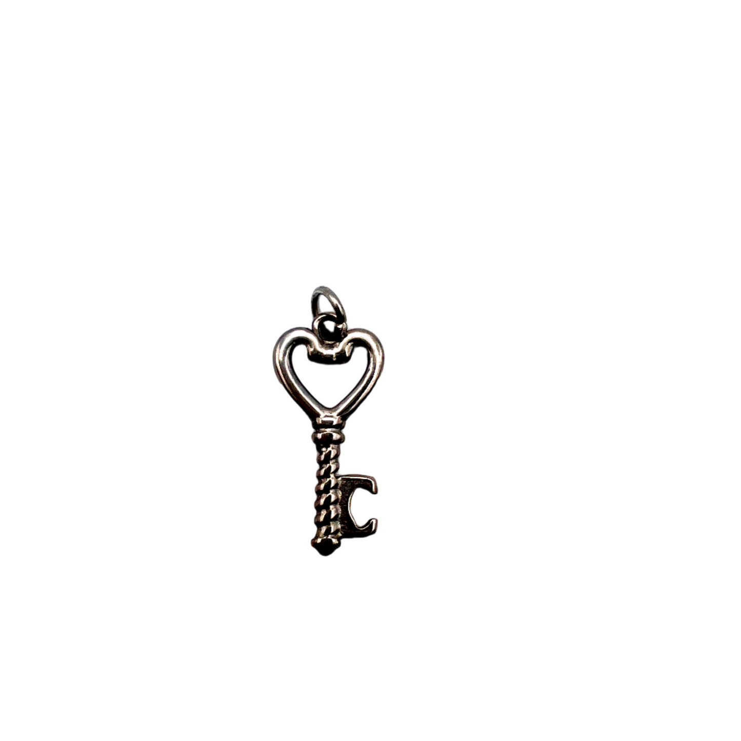 Silver key-shaped charm on a white background