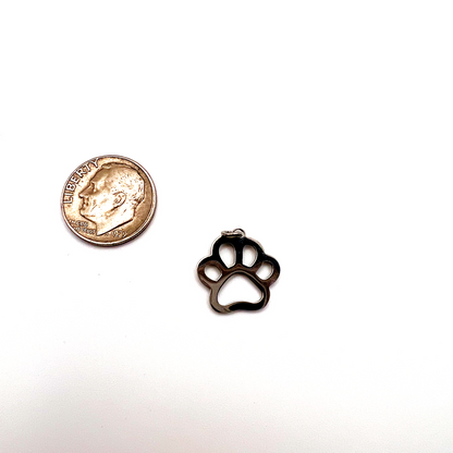 Small black paw print charm next to a U.S. quarter for size comparison on a white background
