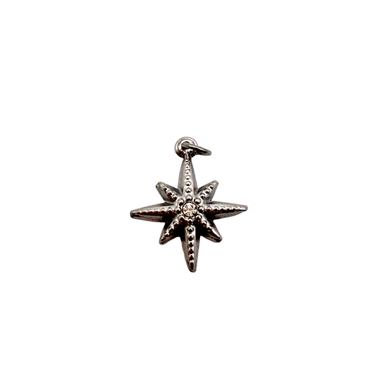 Silver star-shaped pendant on a white background