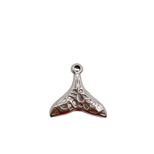 Silver whale tail charm on a white background